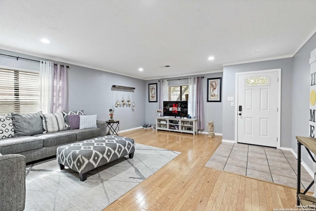 living area with baseboards, recessed lighting, wood finished floors, and crown molding