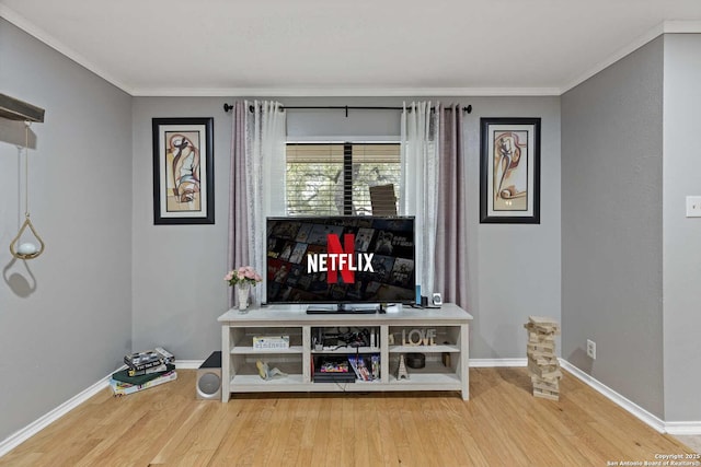 interior space featuring ornamental molding, baseboards, and wood finished floors