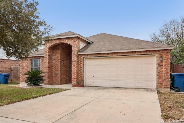 view of front facade featuring an attached garage, brick siding, fence, concrete driveway, and roof with shingles