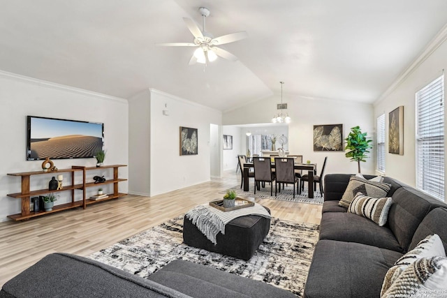 living area with lofted ceiling, ornamental molding, light wood-style flooring, and a ceiling fan