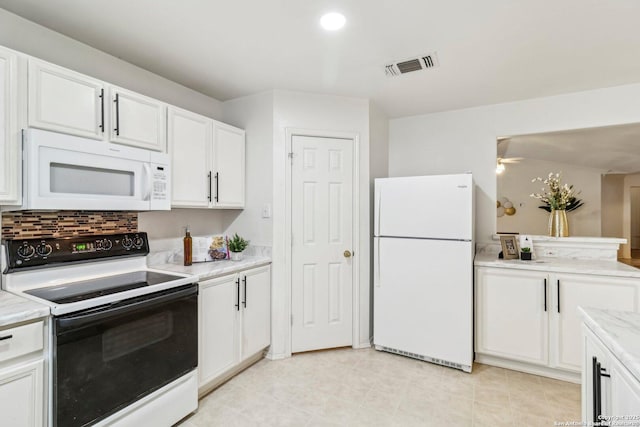 kitchen with white appliances, white cabinetry, visible vents, and decorative backsplash