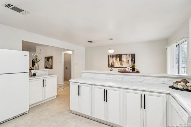 kitchen with white appliances, visible vents, decorative light fixtures, and white cabinets