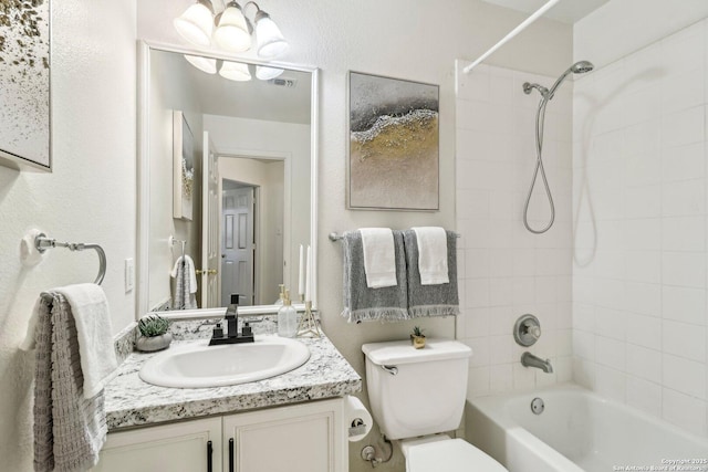 bathroom featuring toilet,  shower combination, visible vents, and vanity