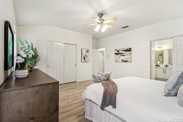 bedroom featuring a closet, visible vents, a ceiling fan, light wood-style floors, and a sink