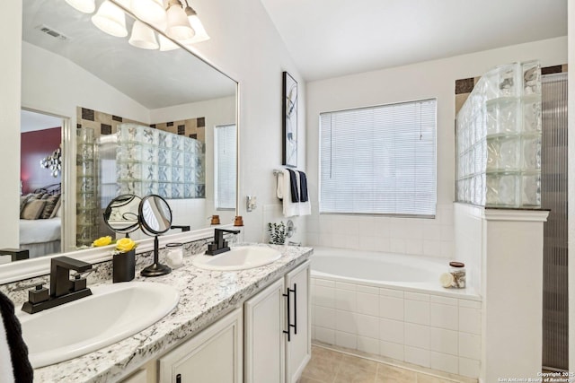 ensuite bathroom featuring a garden tub, visible vents, a sink, and ensuite bath