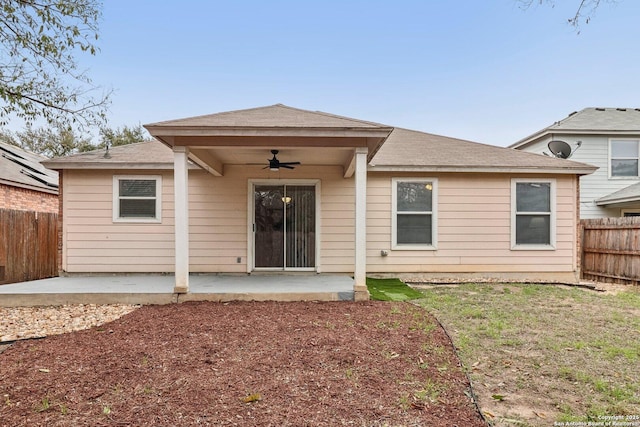 rear view of property featuring ceiling fan, a patio, and fence