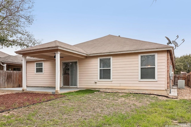 rear view of property featuring a ceiling fan, fence, a lawn, and a patio