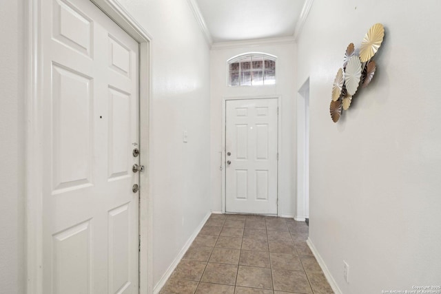 entryway with ornamental molding, light tile patterned flooring, and baseboards