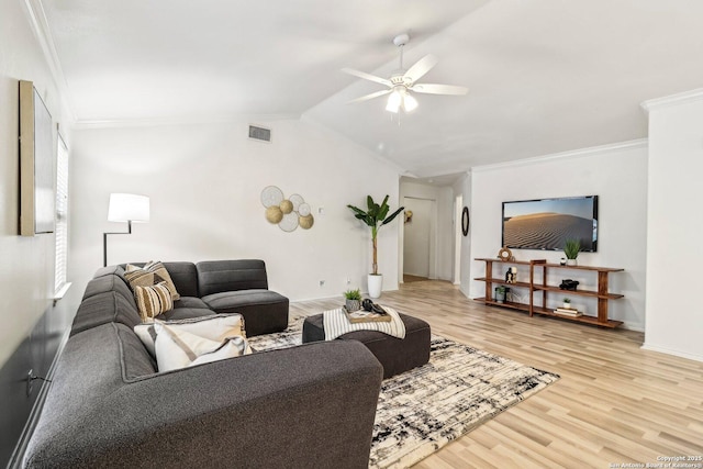 living area with vaulted ceiling, visible vents, crown molding, and light wood-style flooring