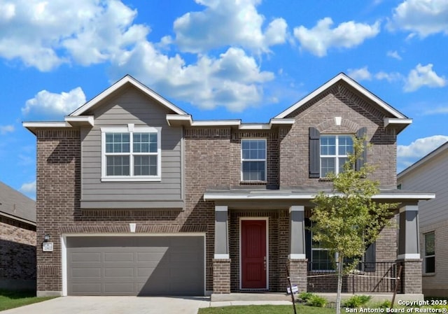 view of front of property featuring a garage, driveway, and brick siding