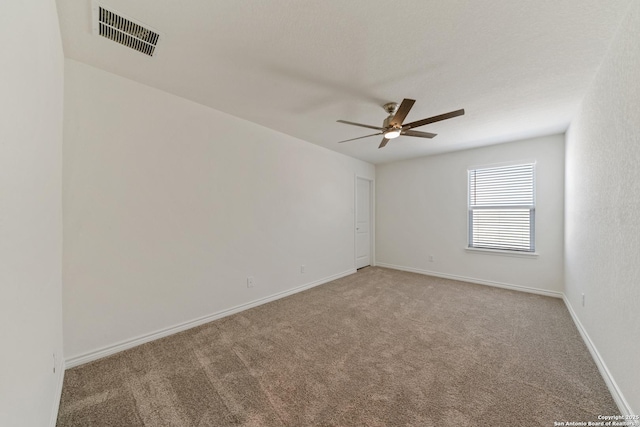 unfurnished room featuring a ceiling fan, baseboards, visible vents, and carpet flooring