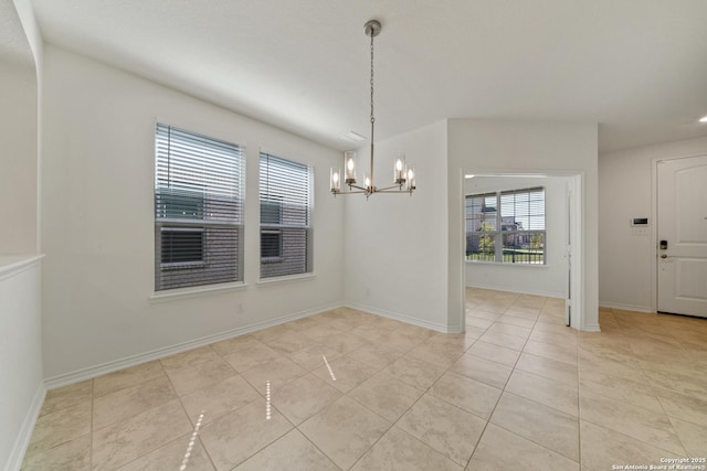 unfurnished dining area featuring an inviting chandelier, light tile patterned floors, and baseboards