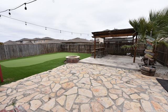 view of patio / terrace featuring a fenced backyard, a fire pit, and a pergola