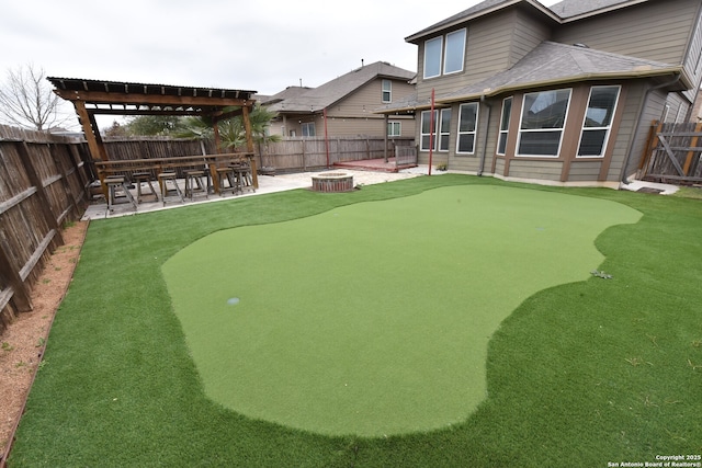 view of community with a fenced backyard and a patio