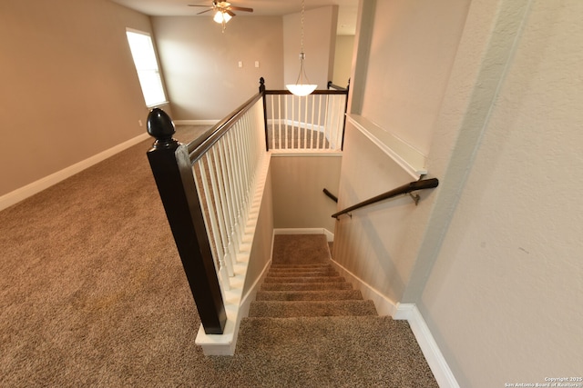 stairs with carpet flooring, ceiling fan, and baseboards