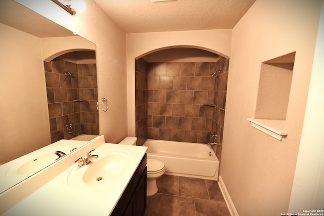 bathroom featuring toilet, a textured ceiling, shower / tub combination, vanity, and tile patterned flooring