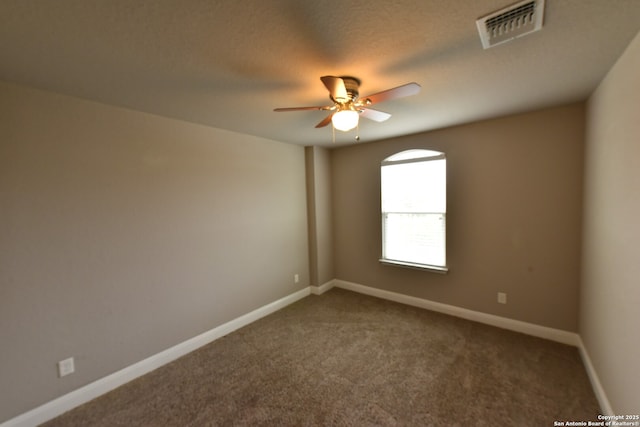 empty room featuring carpet, visible vents, ceiling fan, and baseboards