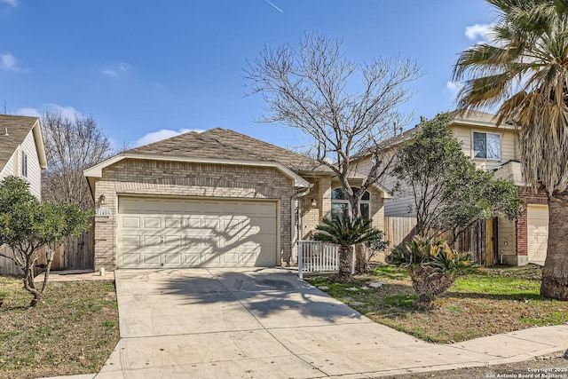 view of front of home featuring a garage, brick siding, fence, and driveway