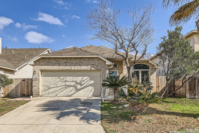 ranch-style home with a garage, driveway, fence, and brick siding