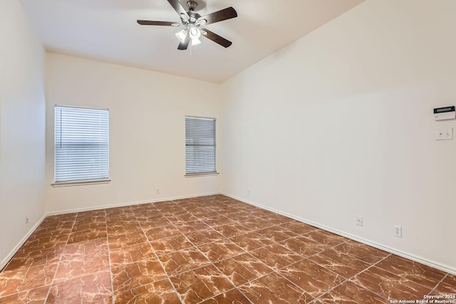 unfurnished room with a ceiling fan and baseboards