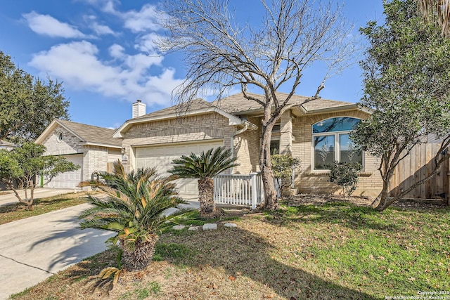 ranch-style house with driveway, a chimney, an attached garage, fence, and brick siding