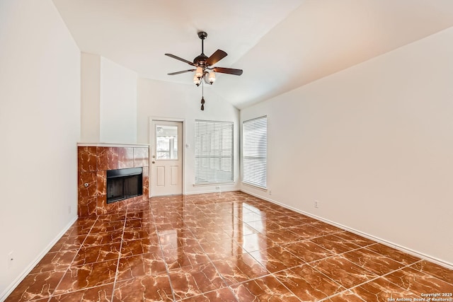 unfurnished living room featuring marble finish floor, a fireplace, lofted ceiling, ceiling fan, and baseboards