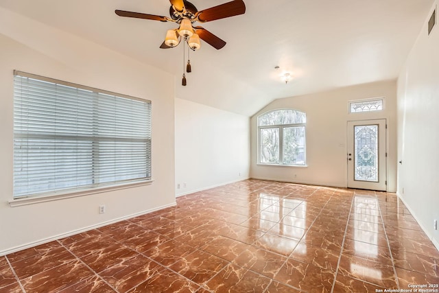 empty room featuring lofted ceiling, marble finish floor, visible vents, and a ceiling fan