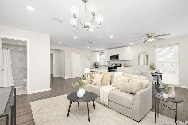 living room featuring wood finished floors, visible vents, and recessed lighting