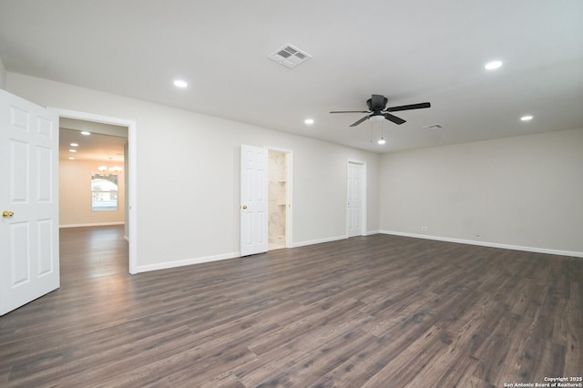 spare room with recessed lighting, visible vents, dark wood finished floors, baseboards, and ceiling fan with notable chandelier