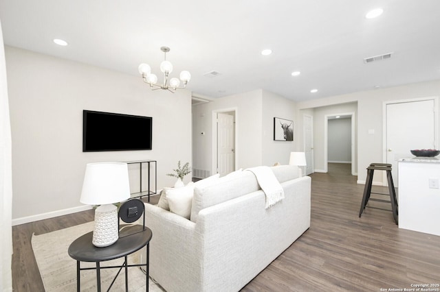 living area with baseboards, visible vents, dark wood-style flooring, a chandelier, and recessed lighting