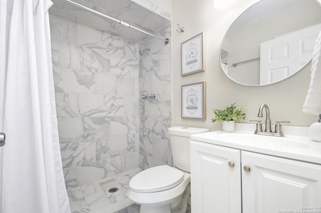 bathroom with toilet, a shower stall, and vanity