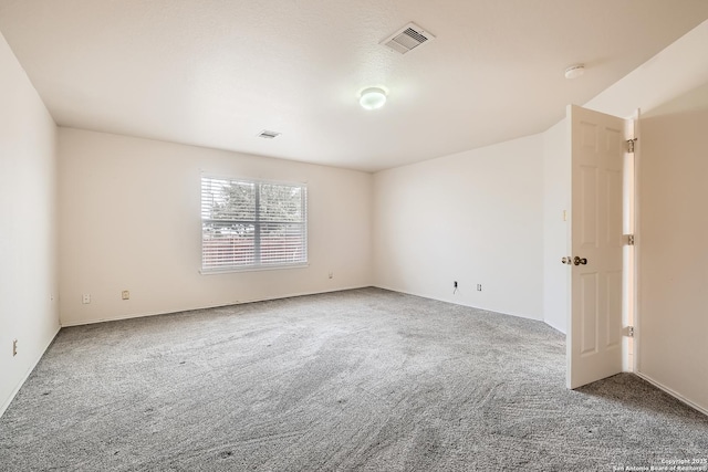 unfurnished room with visible vents and carpet flooring