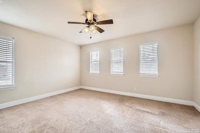 unfurnished room featuring light carpet, ceiling fan, and baseboards