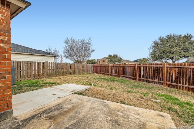 view of yard with a fenced backyard and a patio