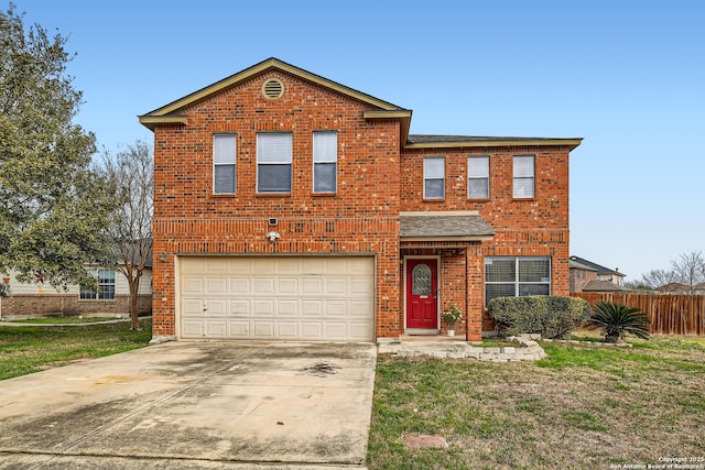 traditional home with concrete driveway, brick siding, fence, and an attached garage