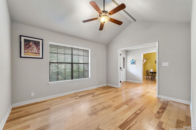 spare room with a ceiling fan, baseboards, light wood-style flooring, and lofted ceiling with beams