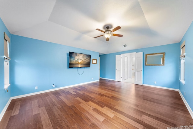 interior space featuring vaulted ceiling, visible vents, ceiling fan, and wood finished floors