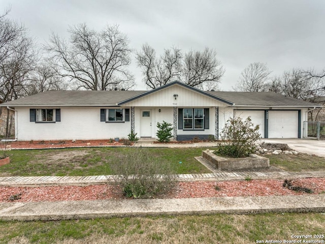 view of front of house with a garage, driveway, and brick siding