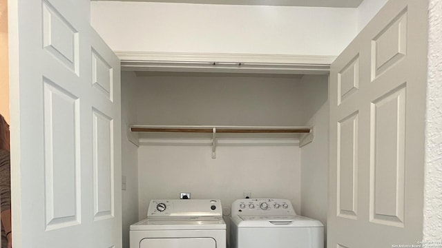 clothes washing area with laundry area and washer and clothes dryer