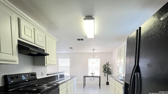 kitchen featuring visible vents, cream cabinets, a textured ceiling, under cabinet range hood, and black appliances