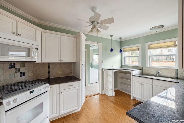 kitchen featuring white appliances, a sink, white cabinetry, light wood-type flooring, and crown molding