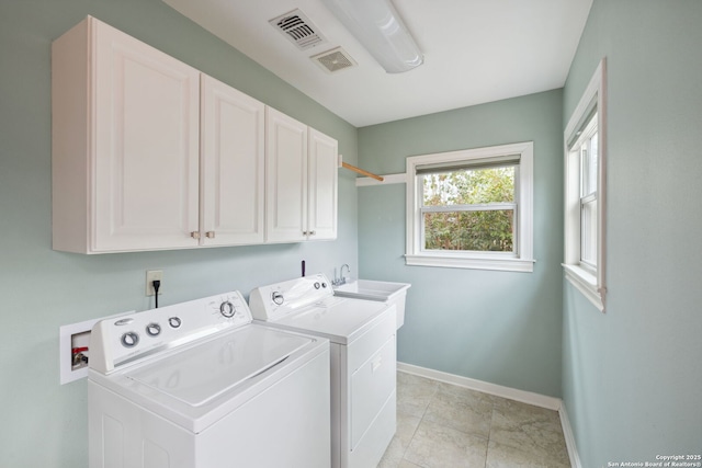 laundry room featuring separate washer and dryer, a sink, visible vents, baseboards, and cabinet space