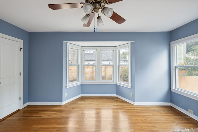 spare room with light wood-type flooring and baseboards