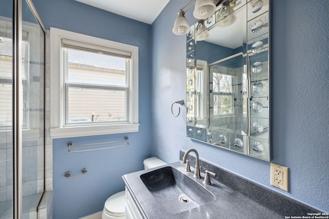 full bathroom with toilet, a wealth of natural light, a sink, and a shower with shower door