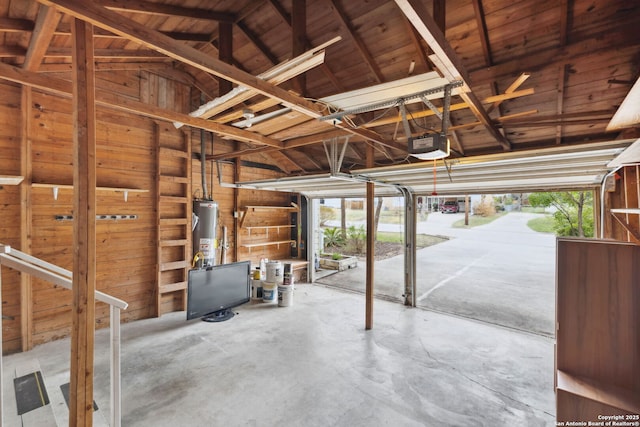 garage with a garage door opener and gas water heater