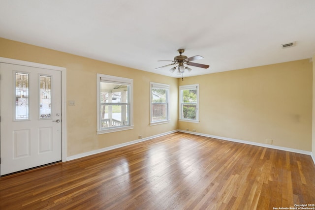 entryway featuring visible vents, ceiling fan, baseboards, and wood finished floors