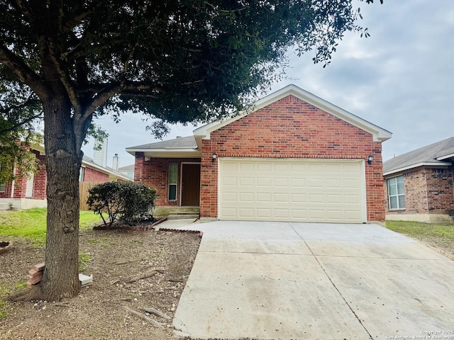 ranch-style house featuring a garage, brick siding, and driveway