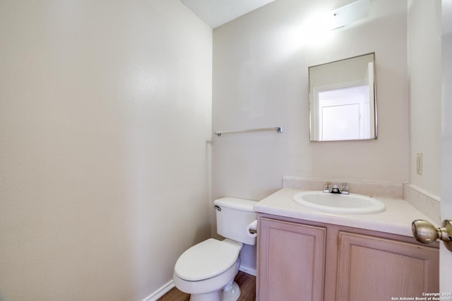 half bathroom featuring toilet and vanity