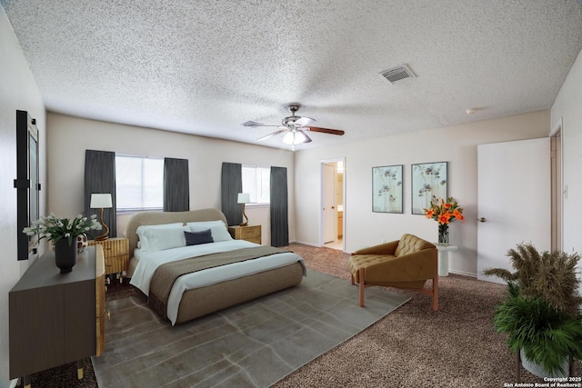 bedroom with ceiling fan, a textured ceiling, dark carpet, and visible vents