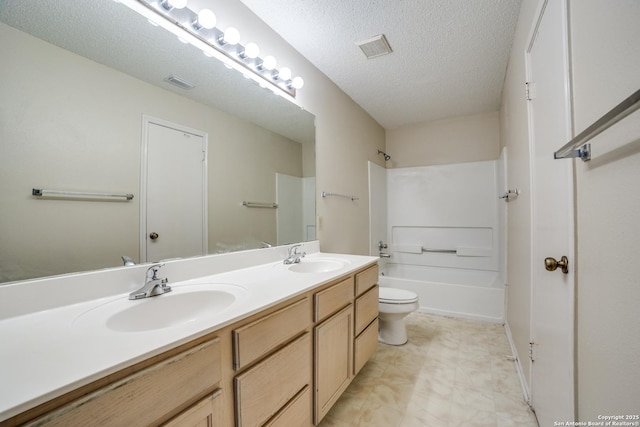 full bath featuring a textured ceiling, a sink, and visible vents